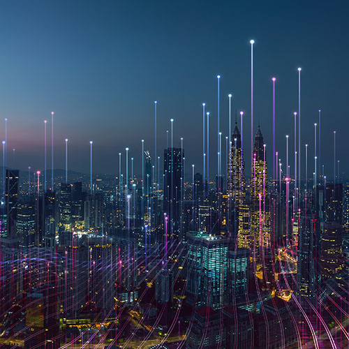 Brightly lit and colourful lines representing graph data are overlaid on a night-time cityscape, rising into plot points in the night sky, above tall buildings.